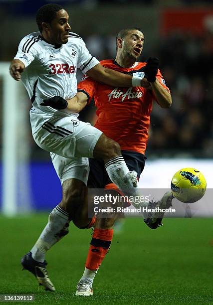 Adel Taarabt of QPR is tackled by Ashley Williams of Swansea during the Barclays Premier League match between Swansea City and Queens Park Rangers at...