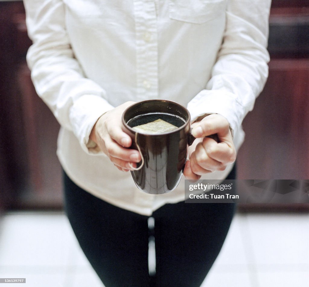 Woman holding  cup of tea