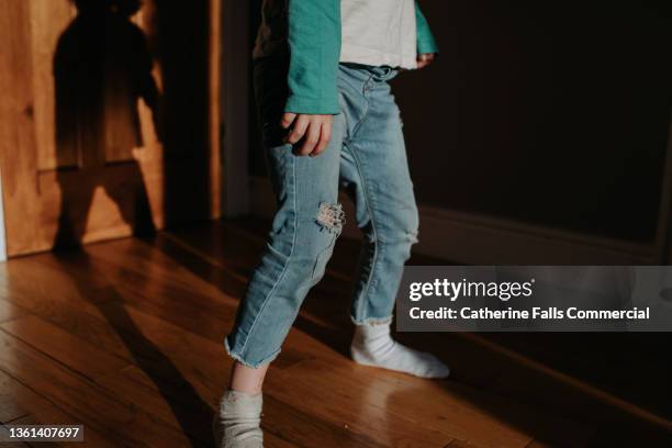 a child performs dance moves in an interior space - ankle socks stock-fotos und bilder