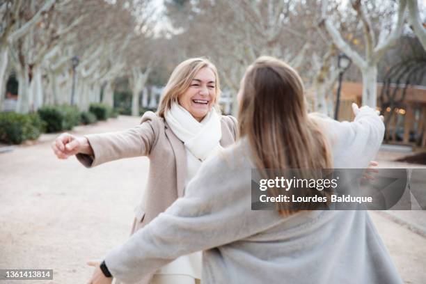 mother holding outstretched arms running towards for hug - held madrid stock-fotos und bilder