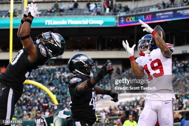 Kenny Golladay of the New York Giants attempts to catch a pass in the end zone as Jared Mayden and Josiah Scott of the Philadelphia Eagles defend...