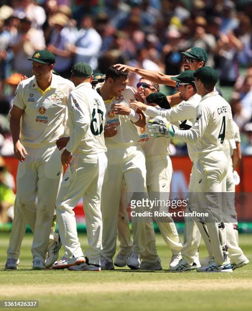 Scott Boland of Australia celebrates with teammates after dismissing Mark Wood of England during day three of the Third Test match in the Ashes...