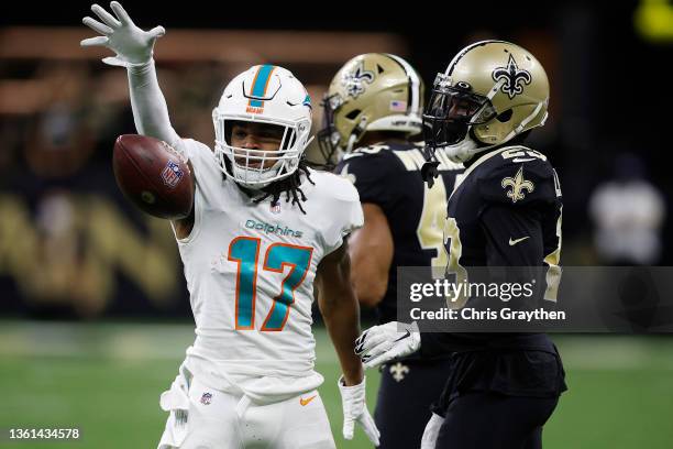 Jaylen Waddle of the Miami Dolphins reacts after catching a pass during the first quarter against the New Orleans Saints at Caesars Superdome on...