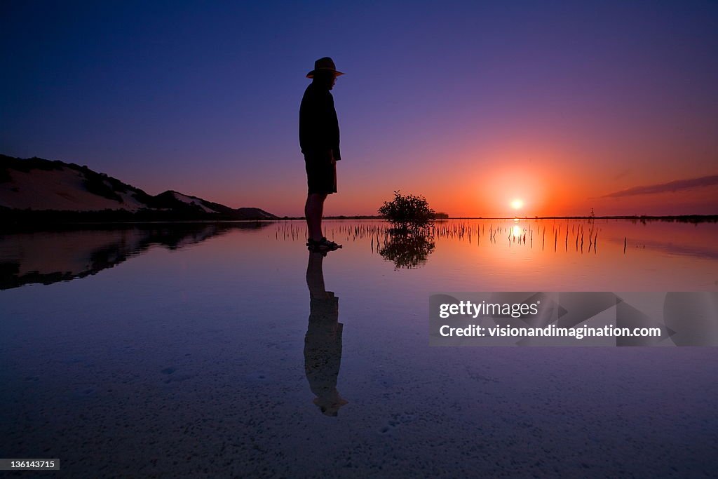 Man Standing In River At Sunset High-Res Stock Photo - Getty Images