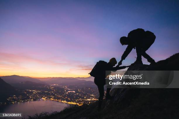 hiking couple climb up mountain ridge - reaching summit stock pictures, royalty-free photos & images