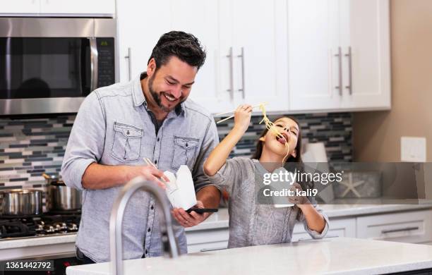 multiracial girl, father eat chinese take out in kitchen - chinese takeout stock pictures, royalty-free photos & images