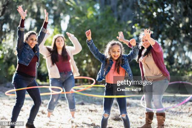 hispanic girl with family at park playing with hoops - hooping stock pictures, royalty-free photos & images