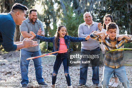 Multi-generation Hispanic family, children hooping Multi-generation Hispanic family, children hooping
