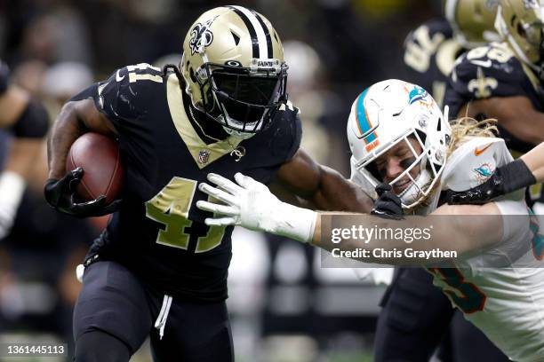 Alvin Kamara of the New Orleans Saints evades a tackle by Andrew Van Ginkel of the Miami Dolphins in the third quarter of the game at Caesars...