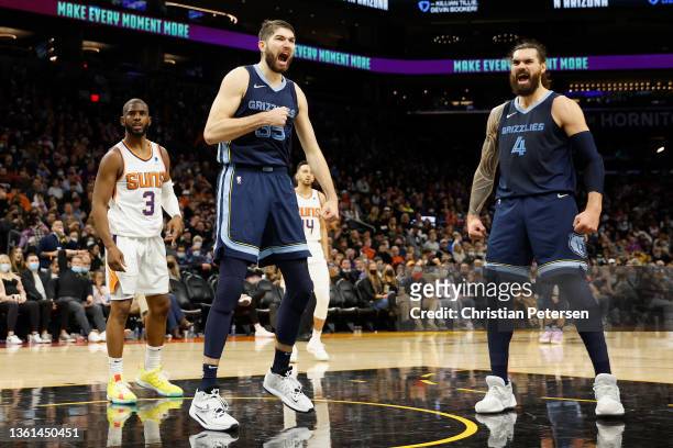 Killian Tillie of the Memphis Grizzlies celebrates alongside Steven Adams after a slam dunk against the Phoenix Suns during the second half of the...