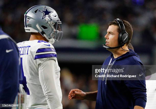Dak Prescott of the Dallas Cowboys talks with offensive coordinator Kellen Moore in the game against the Washington Football Team at AT&T Stadium on...