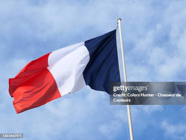 the national flag of france and cloudy sky - bandera francesa fotografías e imágenes de stock