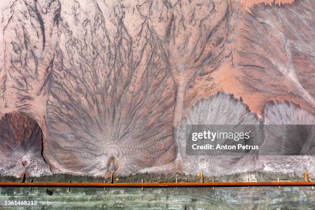 abstract patterns of a tailing dump near an iron ore quarry. aerial view - water pollution stock-fotos und bilder