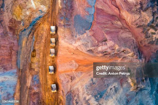 aerial view of open pit iron ore and heavy mining equipment. heavy mining truck for transporting iron ore - coal mine stock photos et images de collection