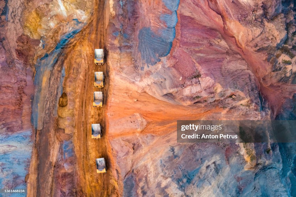 Aerial view of open pit iron ore and heavy mining equipment. Heavy mining truck for transporting iron ore