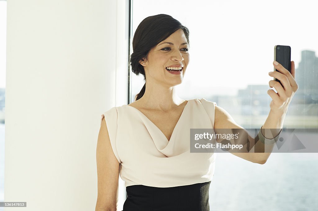 Business woman using video call on mobile phone