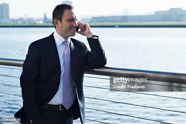 business man using mobile phone - ballustrade stockfoto's en -beelden