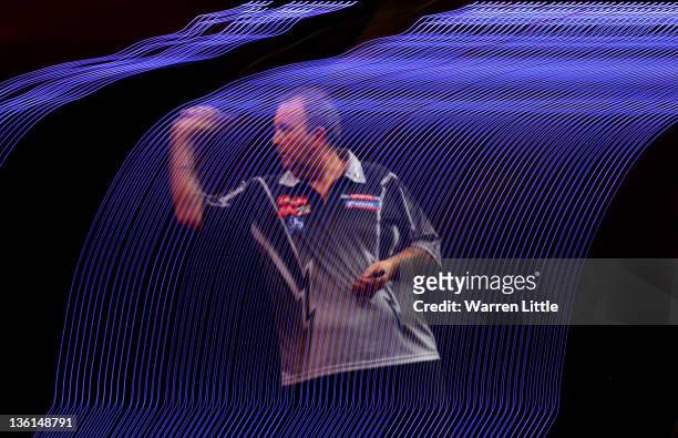 Phil Taylor of England throws in his match against Dave Chisnall of England during Day 10 of the 2012 Ladbrokes.com World Darts Championship at...