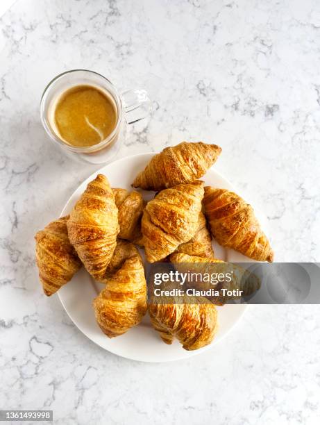 cup of coffee and croissants on a plate on white background - croissant white background stock-fotos und bilder