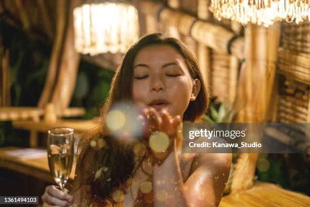 beautiful asian woman blowing confetti - glamour asian stock pictures, royalty-free photos & images