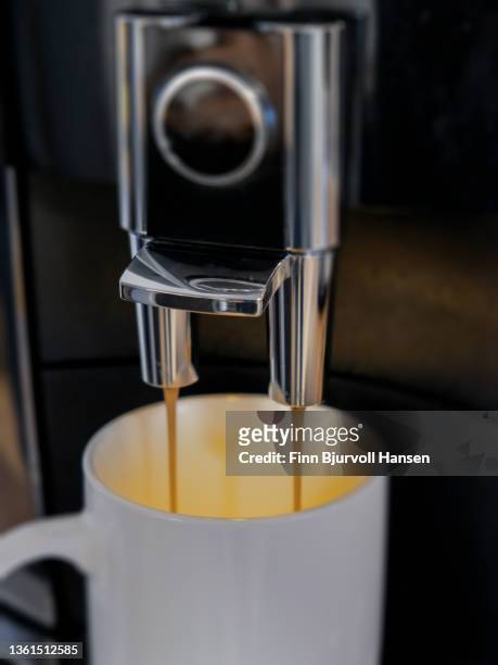 machine of coffee with a cup of warm and creamy coffee - finn bjurvoll stock pictures, royalty-free photos & images