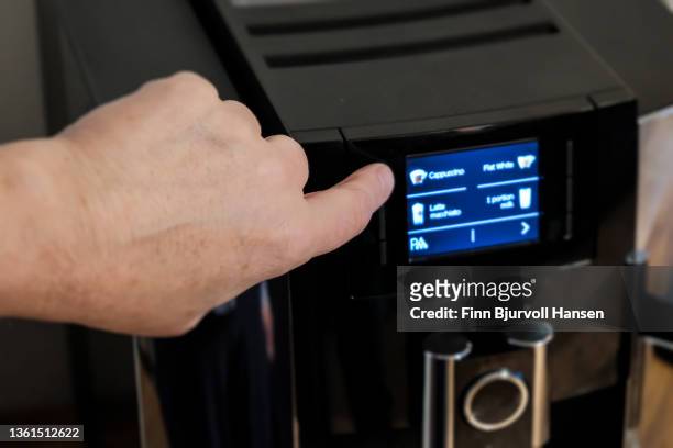 fingerpushing a button on a coffee machine - finn bjurvoll stock pictures, royalty-free photos & images