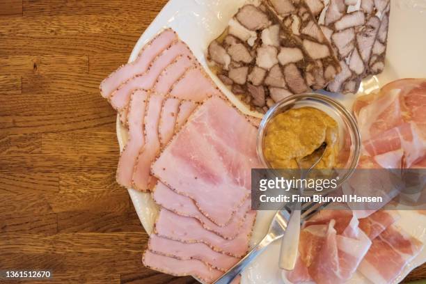 meat spread on a platter. bowl of mustard in the middle - finn bjurvoll stock pictures, royalty-free photos & images