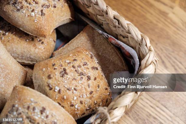 freshly baked rolls in a basket - finn bjurvoll stock pictures, royalty-free photos & images