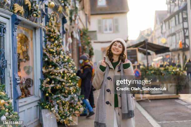 woman walking in colmar  on christmas - strasbourg winter stock pictures, royalty-free photos & images