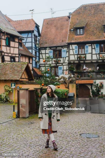 woman walking in alsace town in france - strasbourg winter stock pictures, royalty-free photos & images