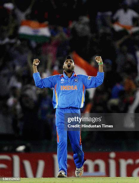 Harbhajan Singh of India celebrates after taking the wicket of Pakistan batsman Shahid Afridi during the 2011 ICC World Cup semi-final match between...