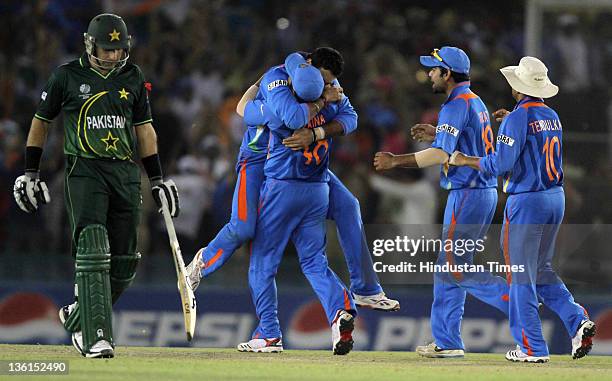 Yuvraj Singh of India celebrates with team-mates after taking the wicket of Pakistan batsman Younus Khan during the 2011 ICC World Cup semi-final...