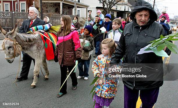 Chester the gray donkey once again led the Palm Sunday procession down College Avenue to Davis Square. Annual service is organized by several local...
