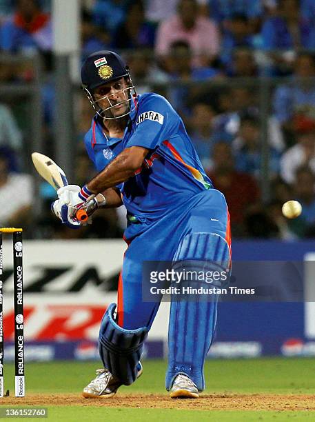 Mahendra Singh Dhoni of India gets in position to play a shot during the 2011 ICC World Cup final match between India and Sri Lanka at Wankhede...