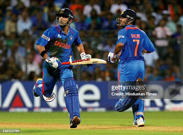 India batsmen Gautam Gambhir and Mahendra Singh Dhoni taking a run during the 2011 ICC World Cup final match between India and Sri Lanka at Wankhede...