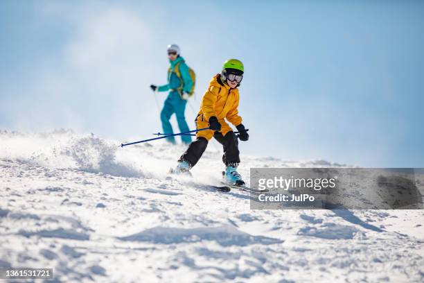 mother and son skiing - family skiing stock pictures, royalty-free photos & images