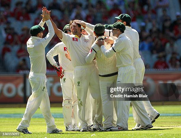 Ben Hilfenhaus of Australia celebrates with team mates after taking the wicket of Rahul Dravid of India during day three of the First Test match...