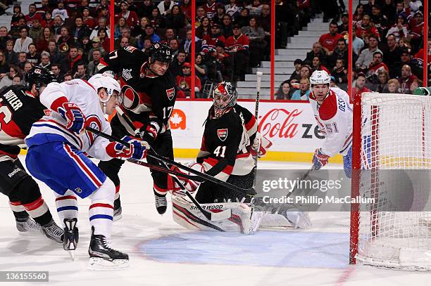 Michael Cammalleri of the Montreal Canadiens fires a rebound into the net for a goal in behind Craig Anderson of the Ottawa Senators during a game at...