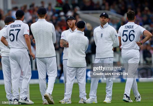 England's captain Ben Stokes and England's James Anderson react after a review overturns a decision to give Australia's Marnus Labuschagne out on day...