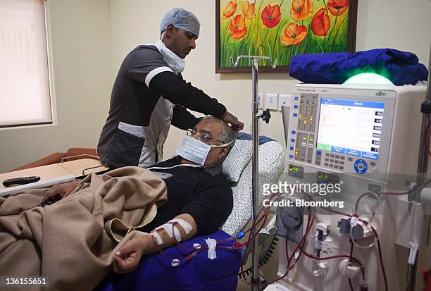 Nurse attends to a patient as he undergoes dialysis, aided by a Fresenius Medical Care AG machine, at a Fortis Healthcare India Ltd. Renkare dialysis...