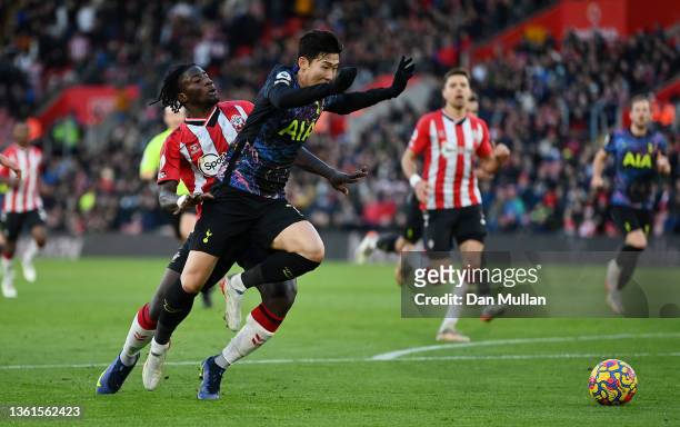 Heung-Min Son of Tottenham Hotspur is tackled by Mohammed Salisu of Southampton leading to a red card and a penalty for Tottenham Hotspur during the...