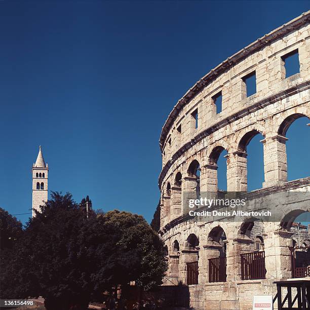 coliseum and tower - pula stock-fotos und bilder