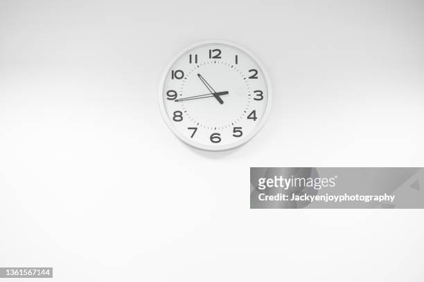 close-up of clock against white background - wall clock stock pictures, royalty-free photos & images