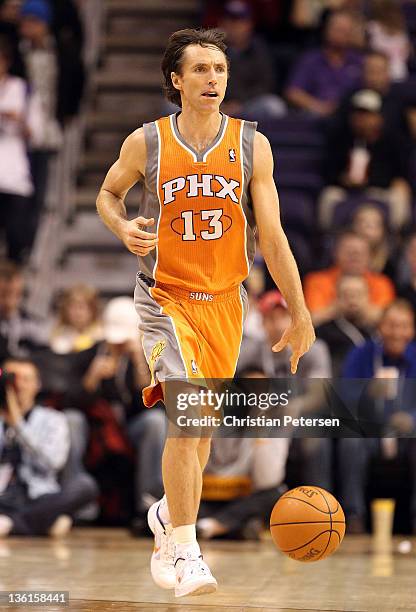 Steve Nash of the Phoenix Suns handles the ball during the season openning NBA game against the New Orleans Hornets at US Airways Center on December...