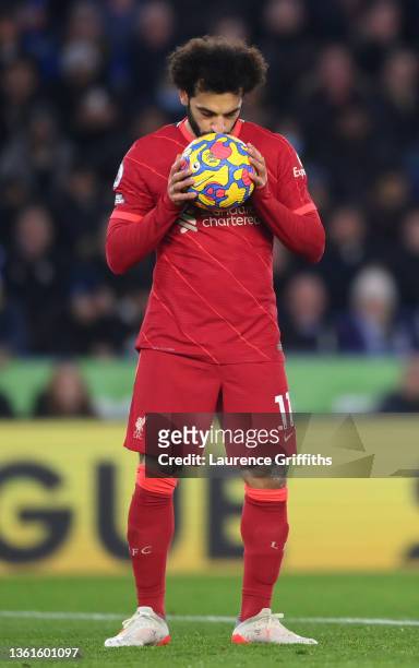 Mohamed Salah of Liverpool kisses the ball before taking a penalty which was later saved by Kasper Schmeichel of Leicester City during the Premier...