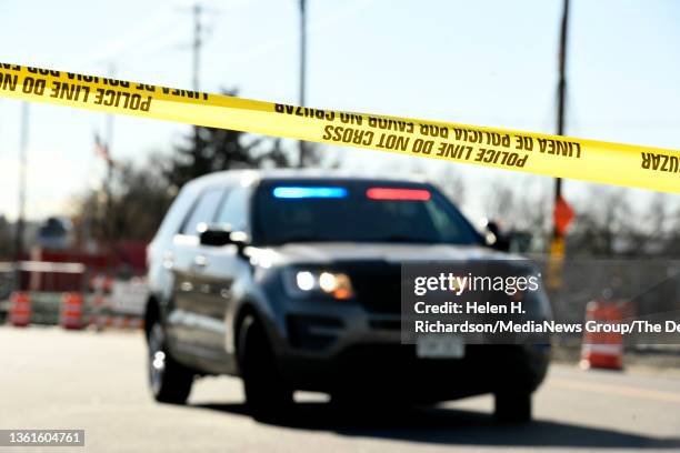 Police officers investigate one of several crime scenes from a shooting spree at 8th Avenue and Zuni Street on December 28, 2021 in Denver, Colorado....