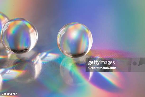 crystal glass ball reflects rainbow colors - glass sphere stock pictures, royalty-free photos & images