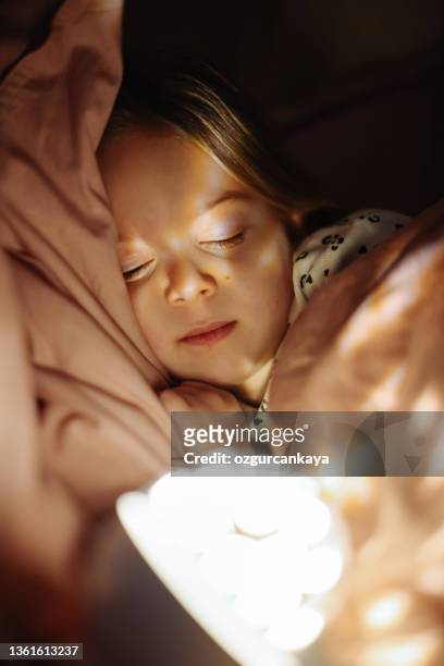 little preschool girl sleeping in comfortable bed - nursery night stock pictures, royalty-free photos & images
