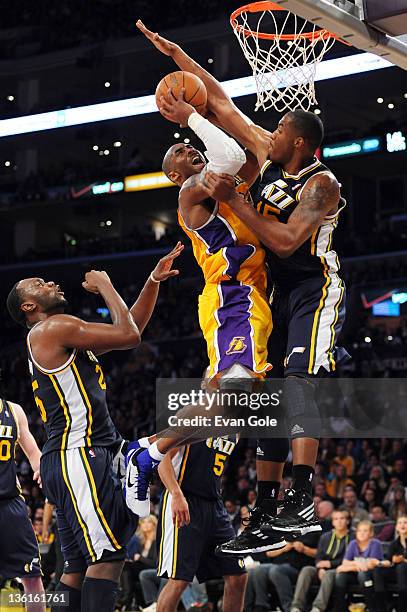 Kobe Bryant of the Los Angeles Lakers goes to the basket against Derrick Favors of the Utah Jazz at Staples Center on December 27, 2011 in Los...