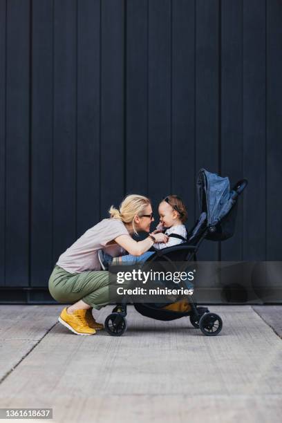 mother and daughter playing outside - mother stroller stock pictures, royalty-free photos & images